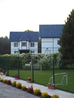 a soccer goal in front of a white house