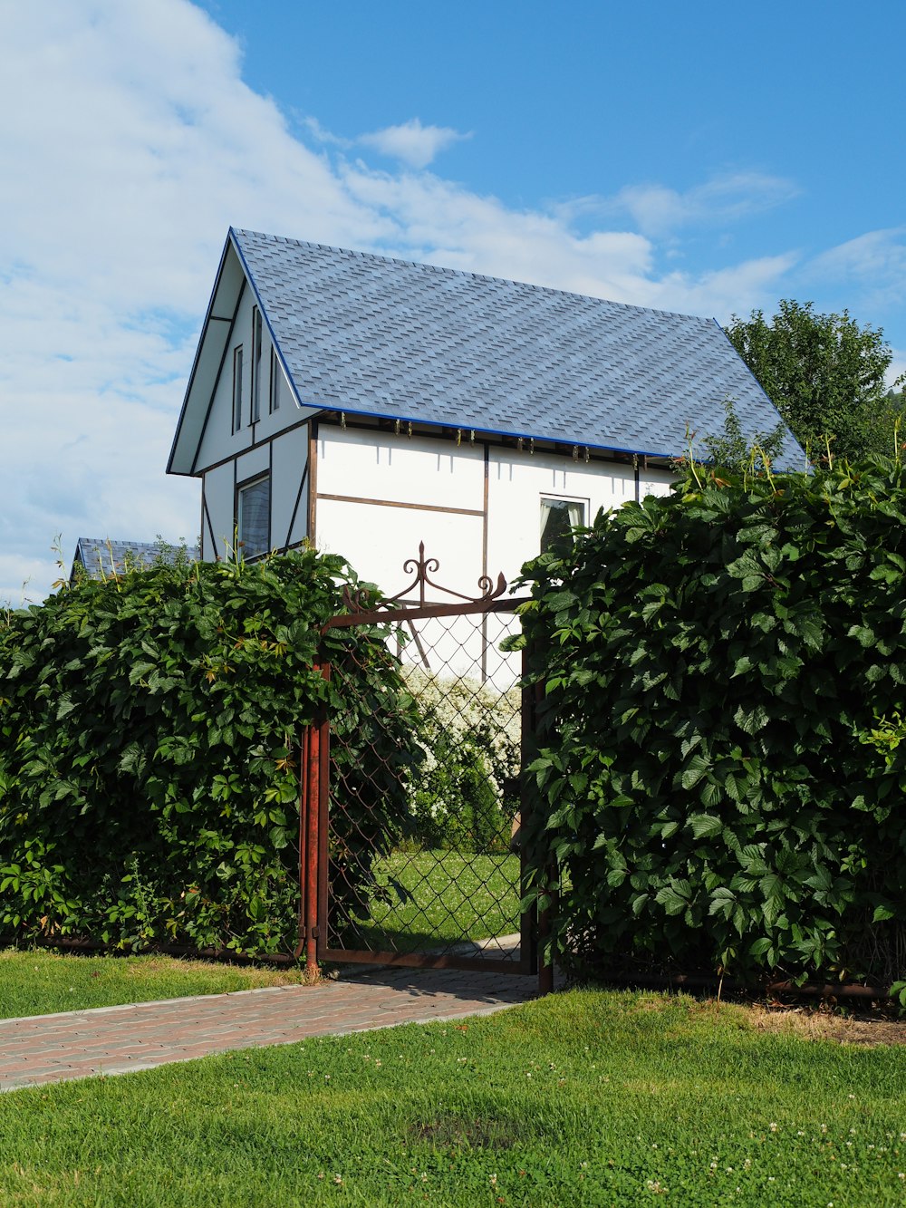 a house behind a fence with a gate