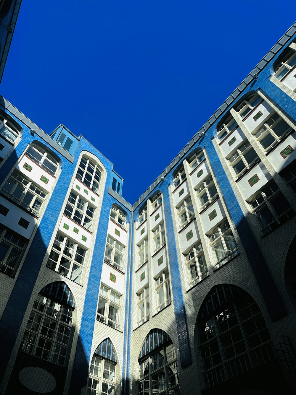 a blue and white building with arched windows