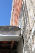 Close-up of a building defect being documented during inspection.