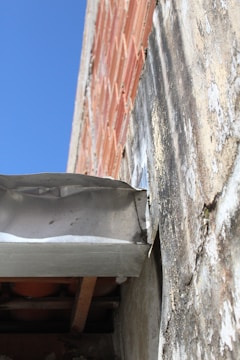 Close-up of a building defect being documented during inspection.