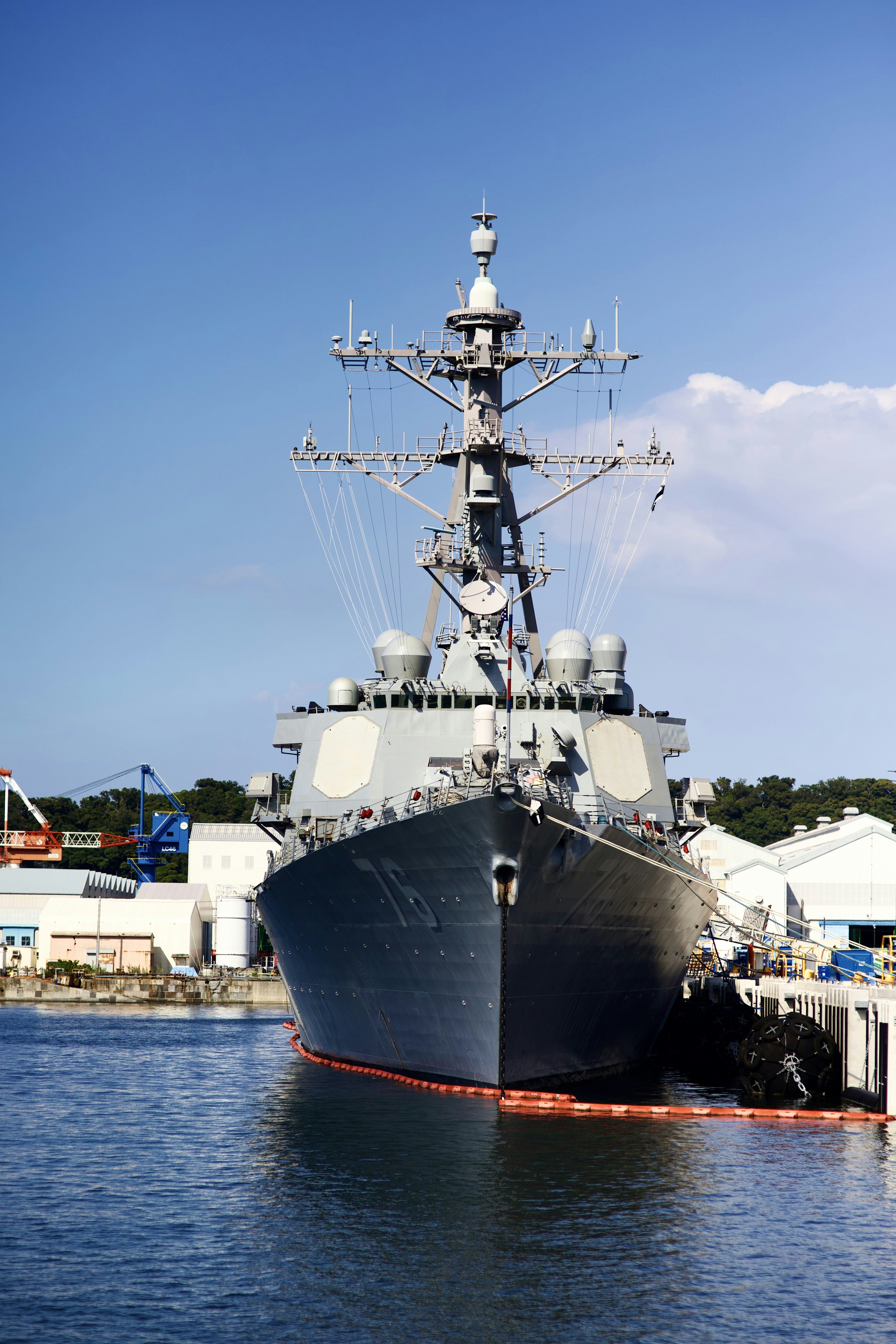 a large ship in the water near a dock