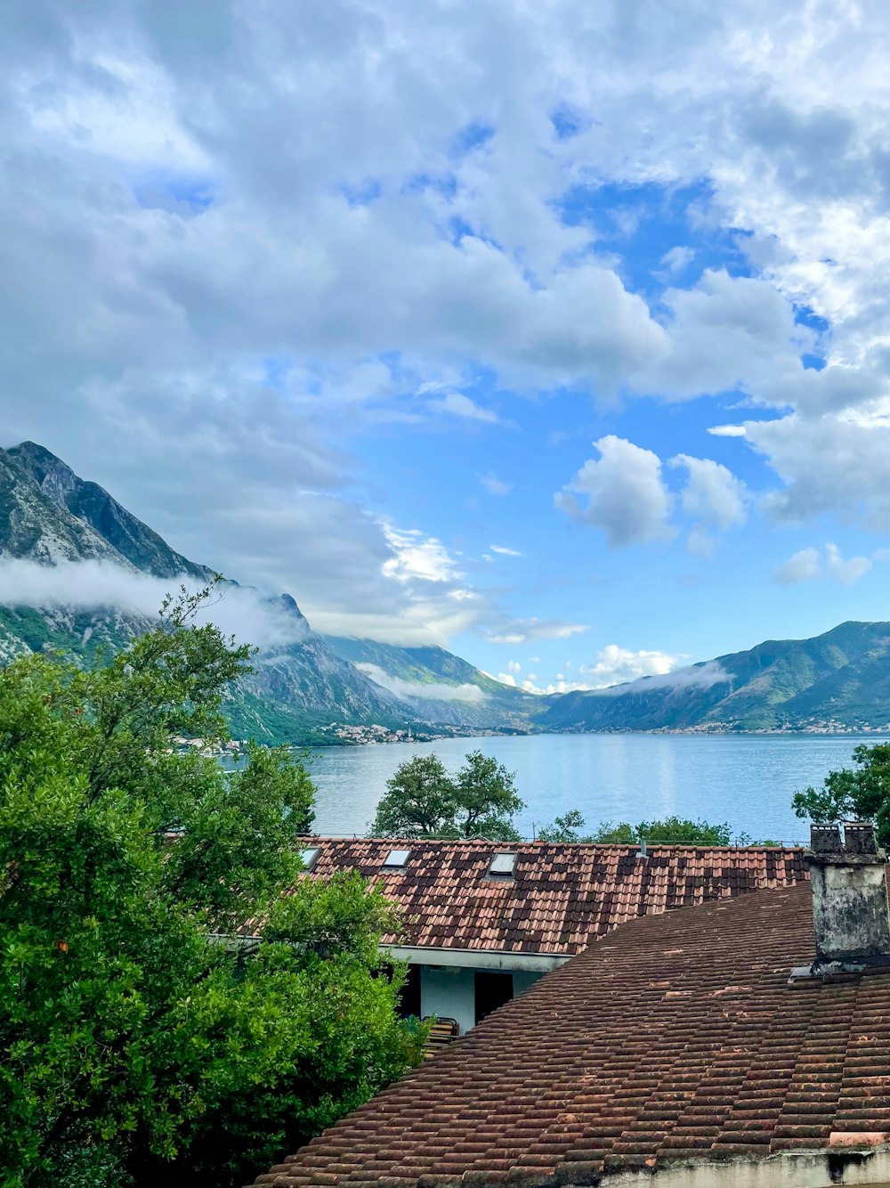 a view of a lake and mountains from a rooftop