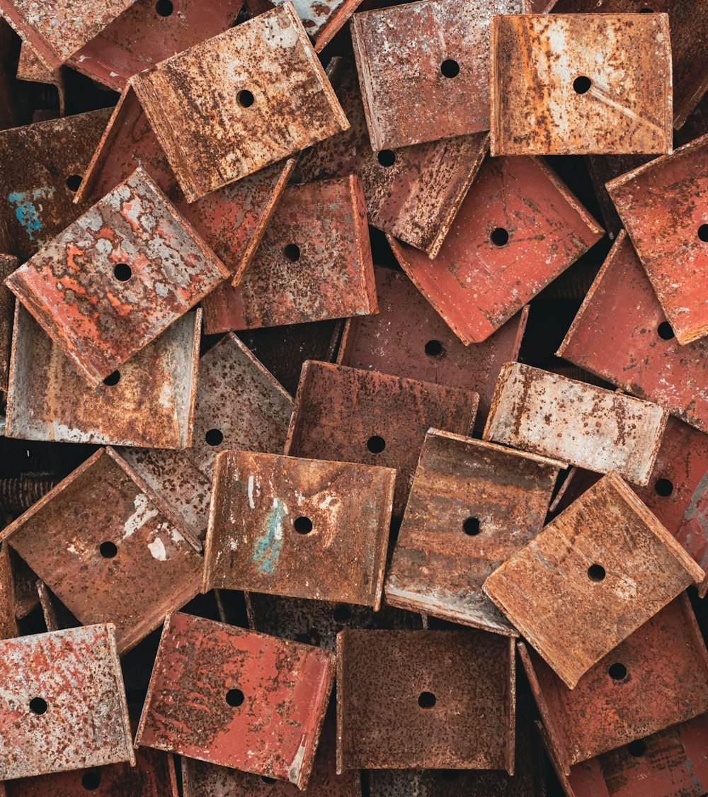 a pile of rusted metal boxes with holes in them
