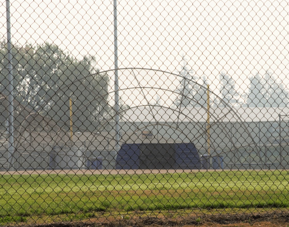 a baseball field behind a chain link fence