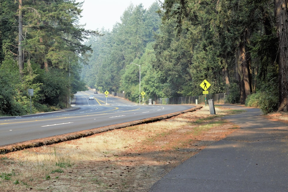 a road with a yellow sign on the side of it