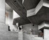 Brutalist commercial interior under construction with concrete walls and geometric lines.