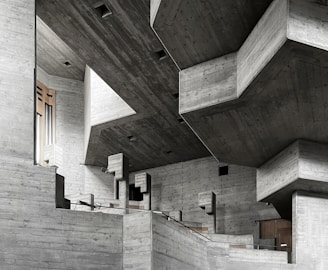 Interior view of a brutalist space with exposed concrete walls and minimalist furnishings