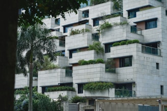 a very tall building with plants growing on it