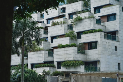 a very tall building with plants growing on it