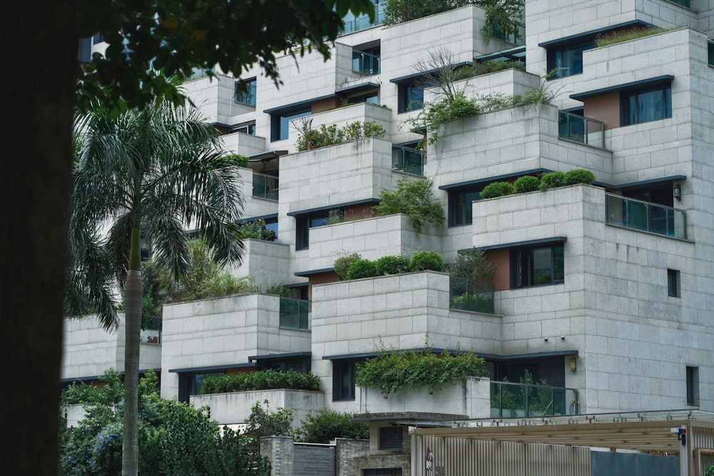 a very tall building with plants growing on it