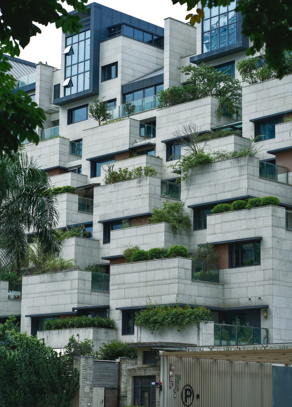 a very tall building with lots of plants growing on it