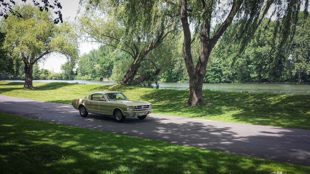 an old car is parked on the side of the road