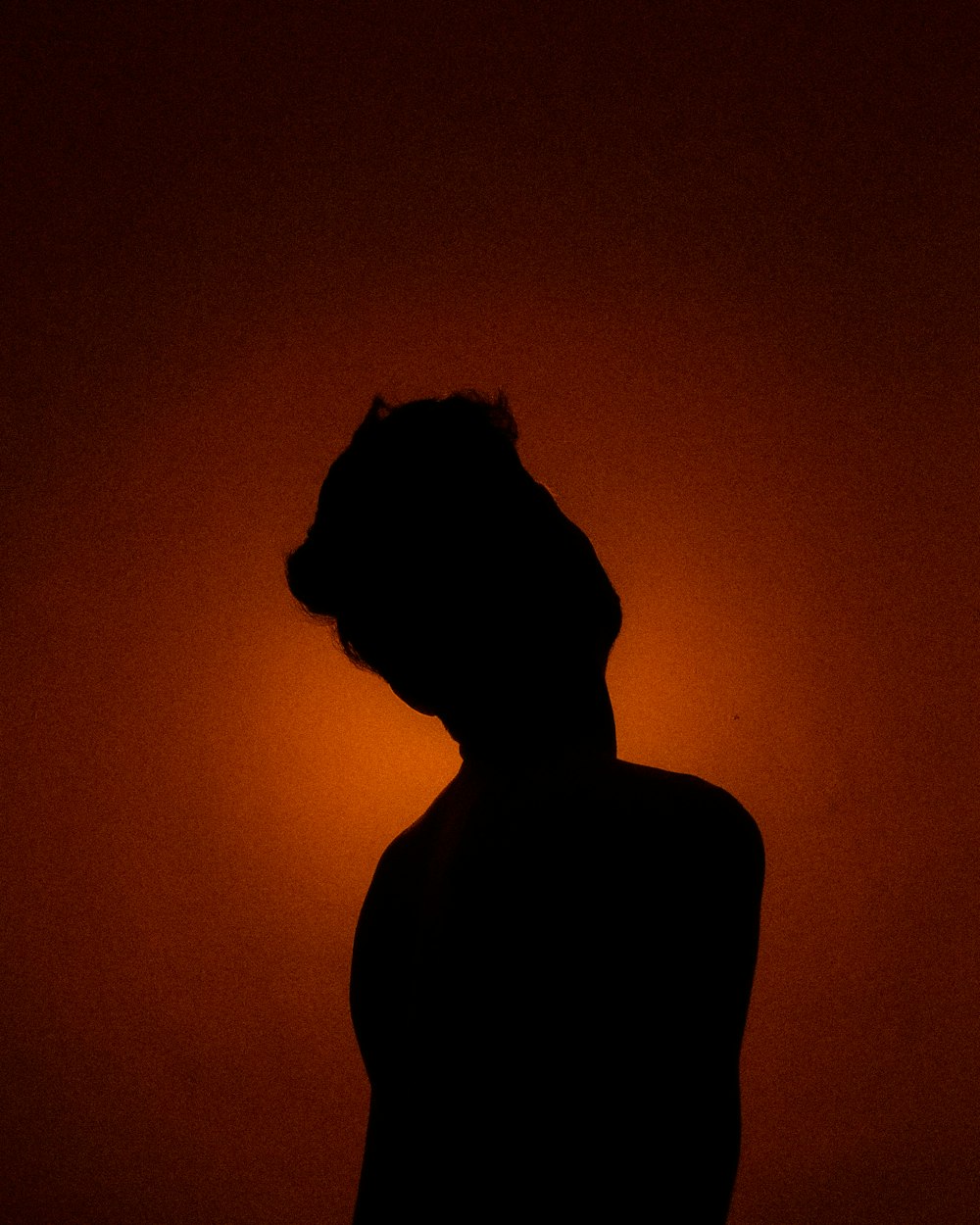 a silhouette of a person in a dark room