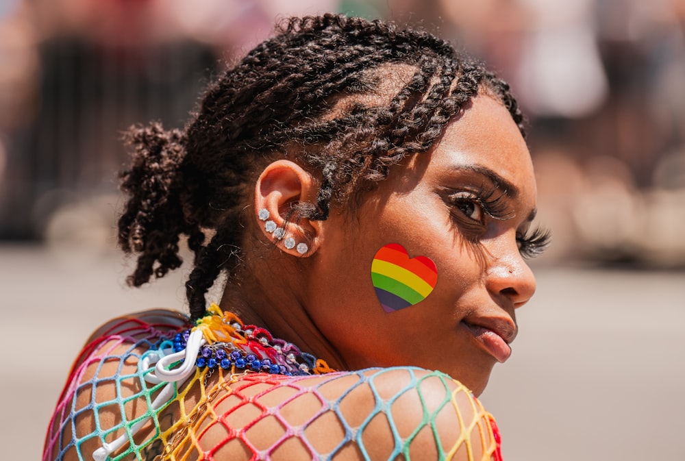 a woman with a rainbow painted on her face