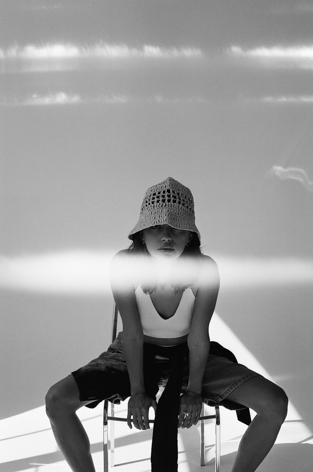 a black and white photo of a person sitting on a chair