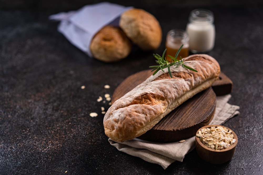 a loaf of bread sitting on top of a wooden cutting board