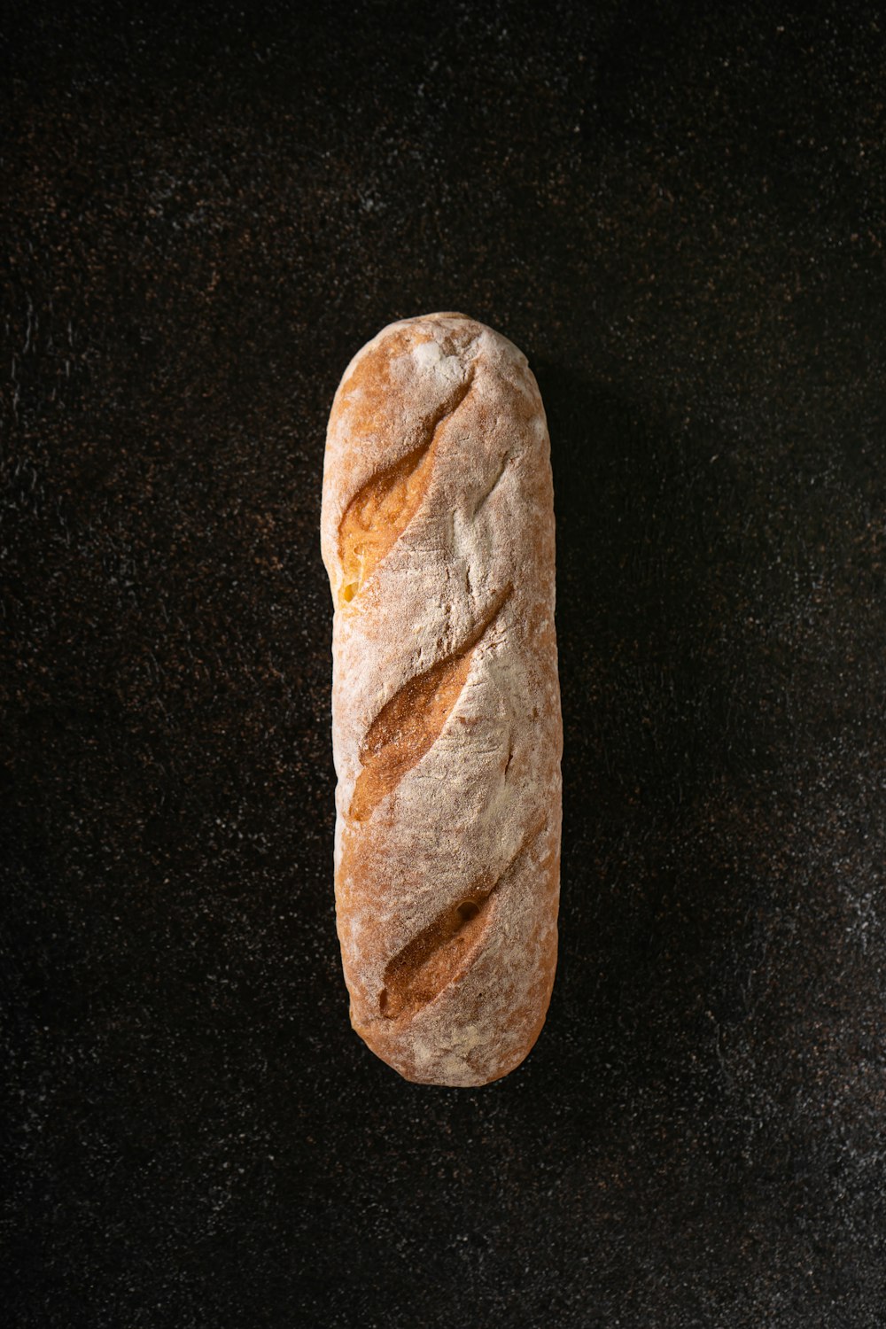 a loaf of bread sitting on top of a black counter