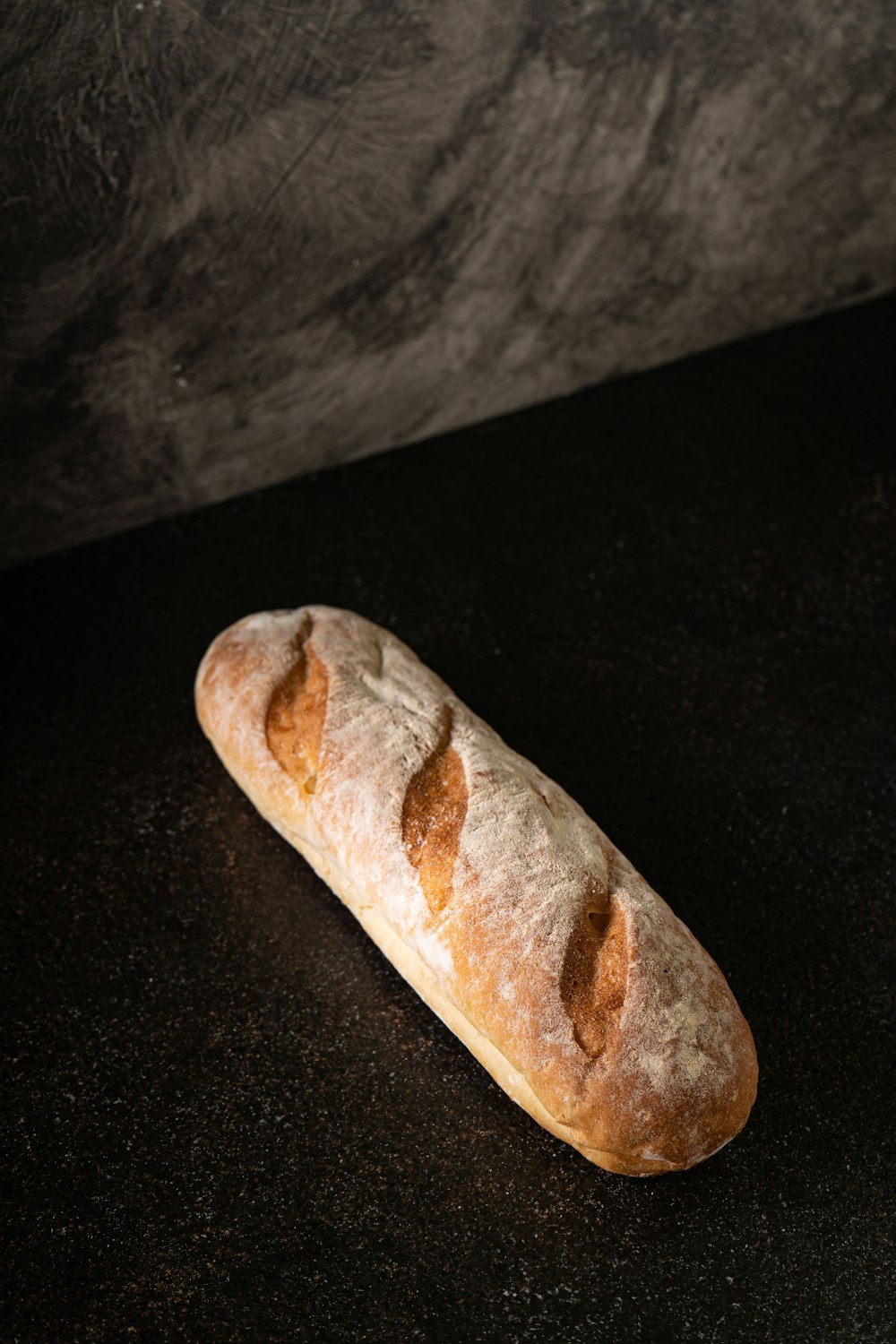 a loaf of bread sitting on top of a black counter