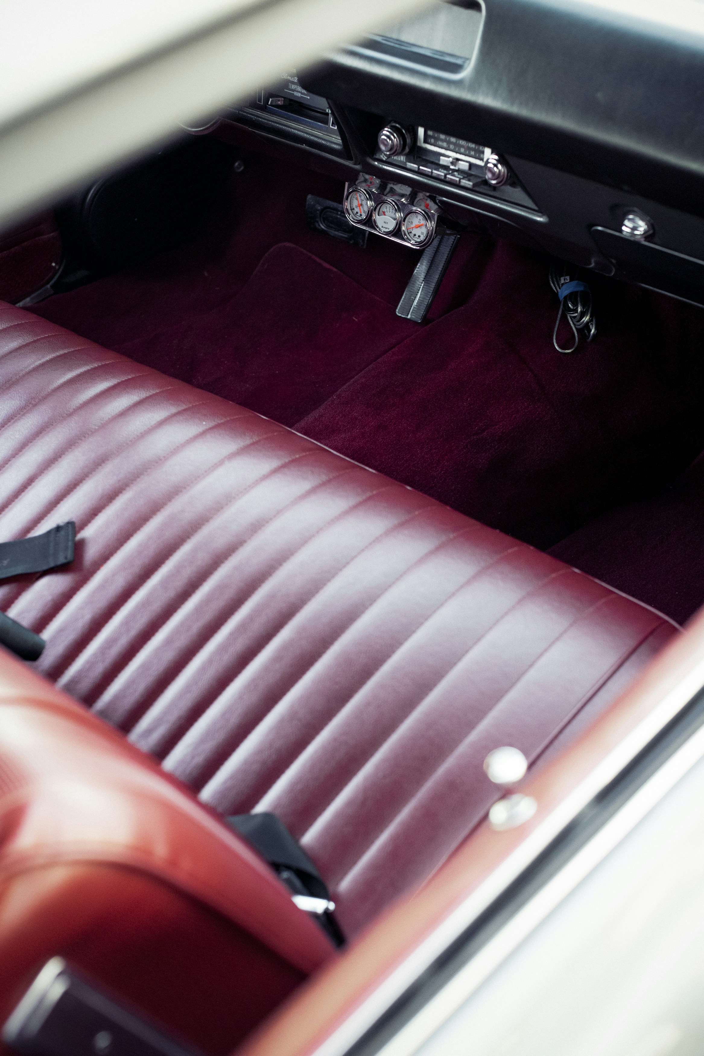 the interior of a car with a red leather seat