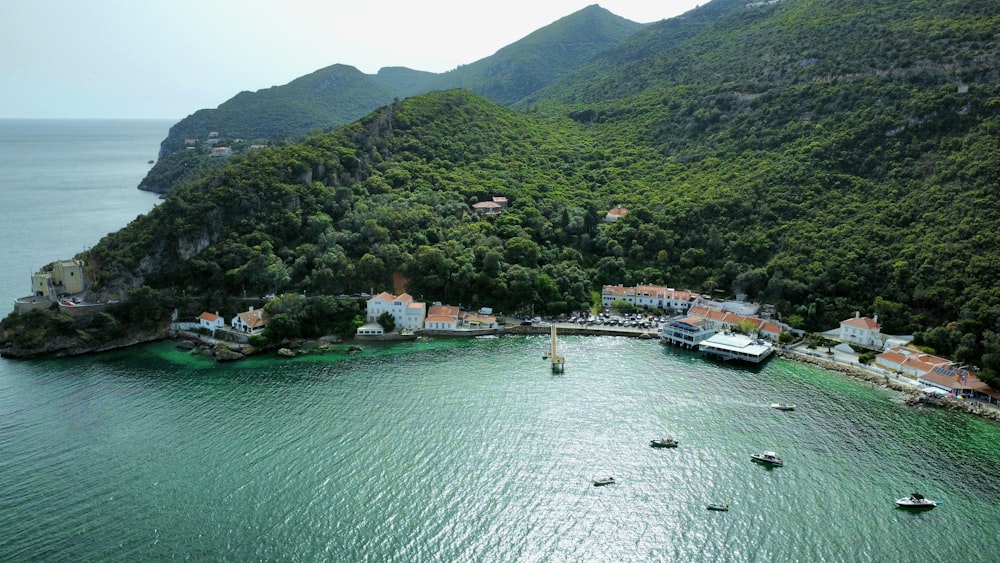 an aerial view of a bay with boats and houses