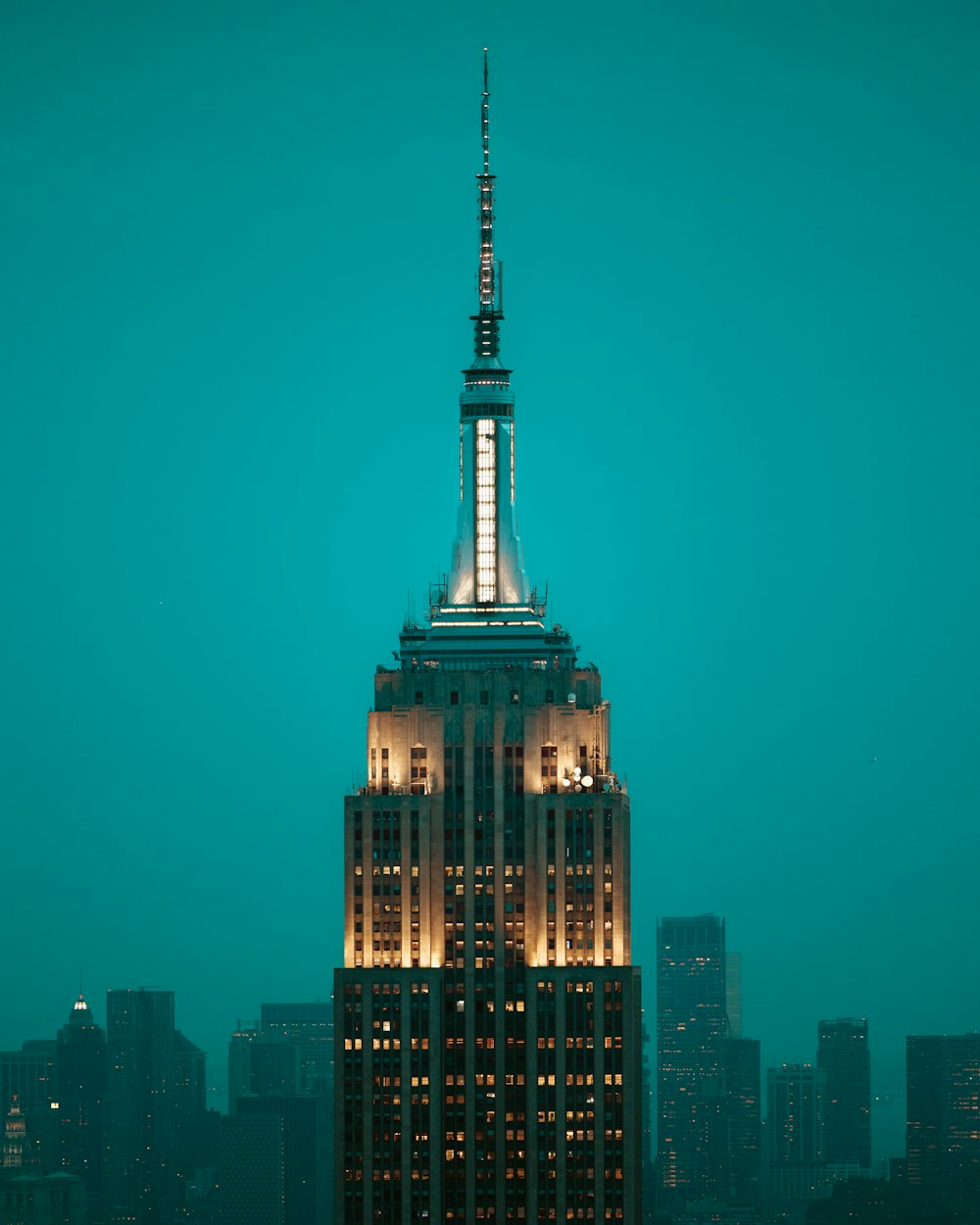 the empire building lit up at night in new york city