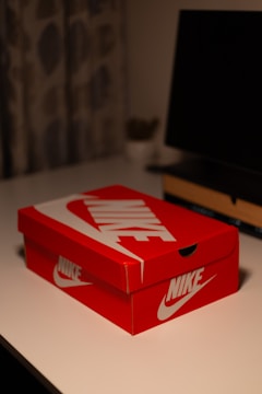 A vibrant photo of a social media influencer unboxing a Nike package in a bright, stylish room.