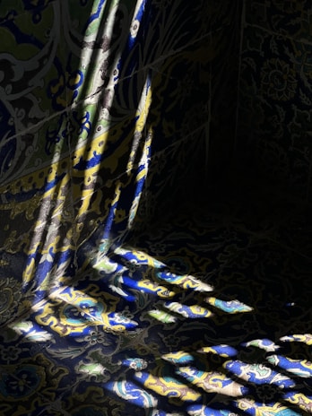 Abstract patterns of light and shadow on a traditional woven fabric.