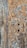 A close-up of intricate geometric wood carvings forming star-like patterns. The aged wood displays a combination of beige, brown, and hints of gray, giving it an antique appearance. The texture and detail emphasize craftsmanship and historical aesthetic.