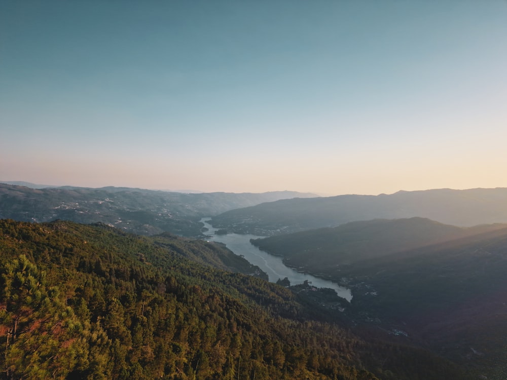 an aerial view of a valley and a body of water