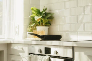 A sleek ceramic pot on a modern kitchen stove with natural light highlighting its glossy finish