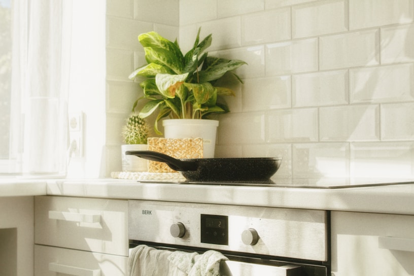 A sunlit farmhouse kitchen with fresh vegetables and a cast iron skillet on the stove.