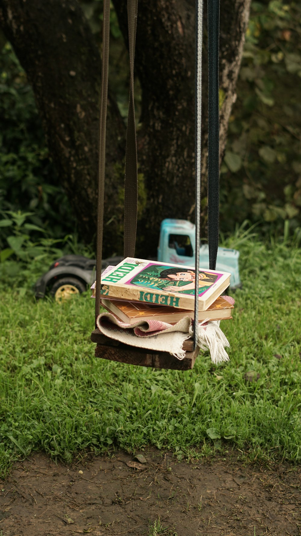 a pile of books sitting on top of a green field