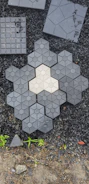 Neatly laid paving stones forming a clean, modern terrace in a garden setting