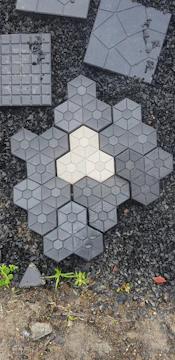 Neatly laid paving stones forming a clean, modern terrace in a garden setting
