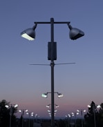Outdoor pathway lit by subtle, stylish LED street lights under a twilight sky.