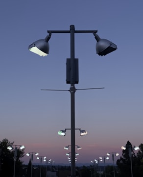 Outdoor pathway lit by subtle, stylish LED street lights under a twilight sky.