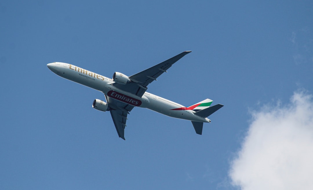 a large jetliner flying through a blue sky,