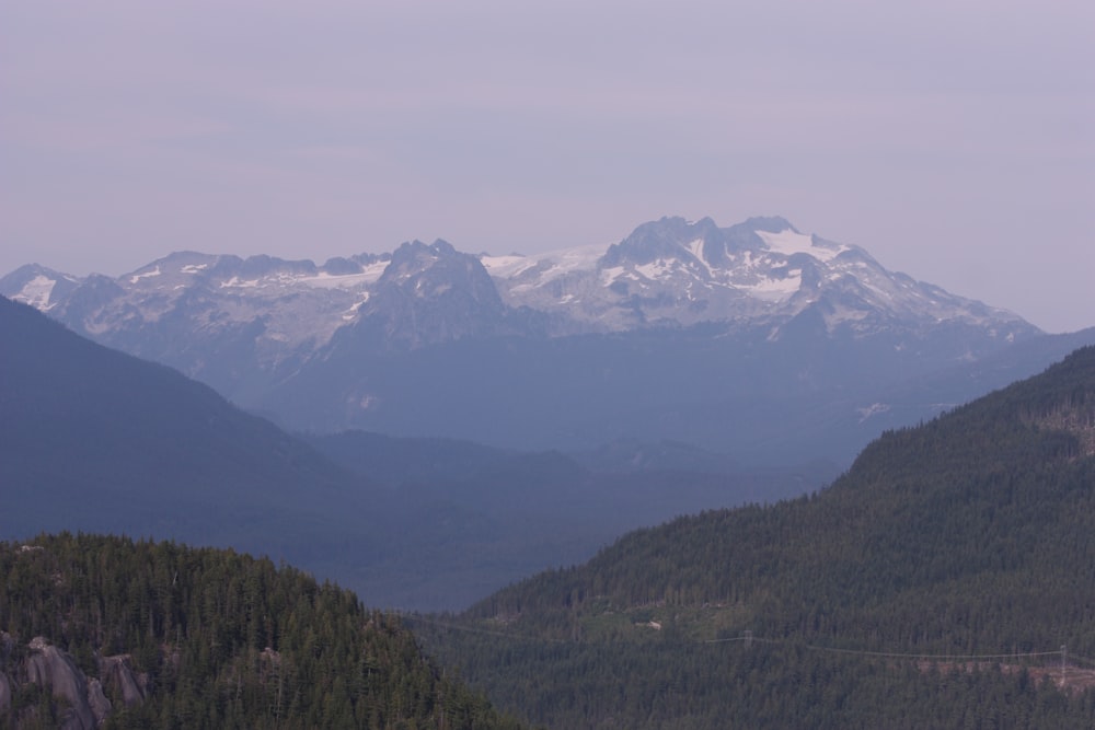 a mountain range with snow capped mountains in the distance