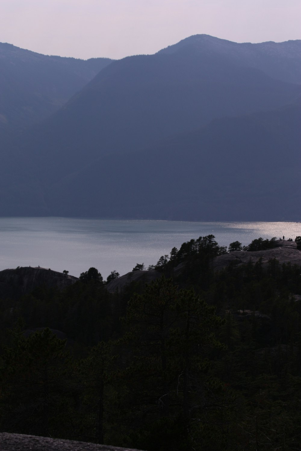 a view of a body of water with mountains in the background