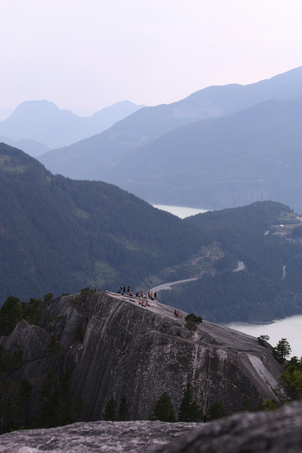 a group of people standing on top of a mountain