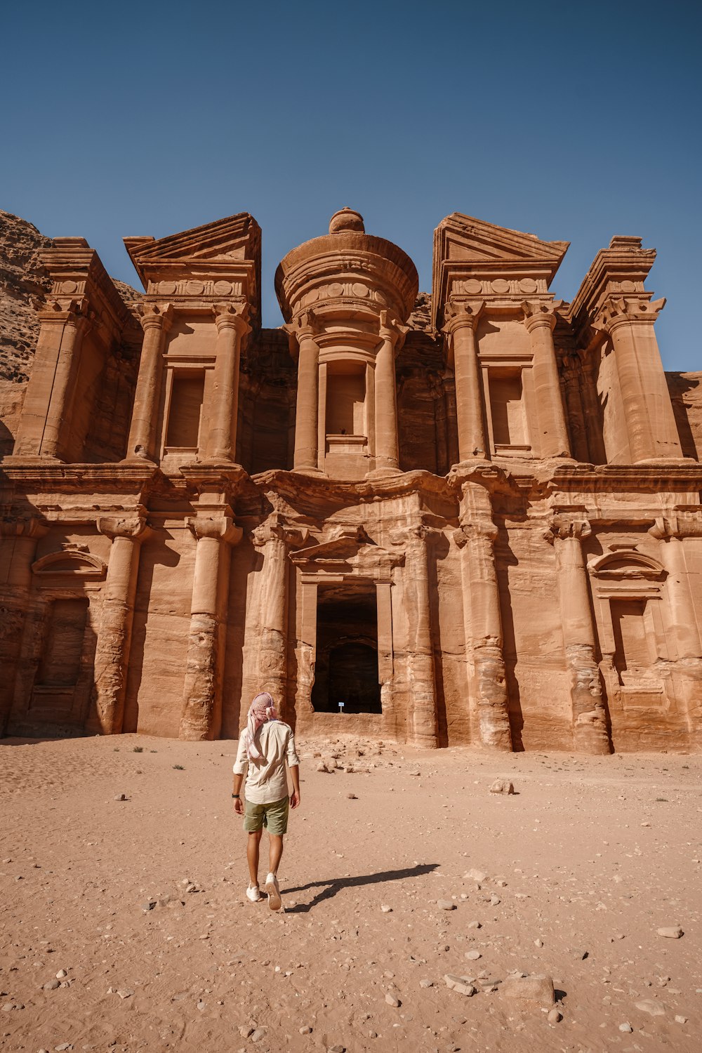 a man standing in front of a large building