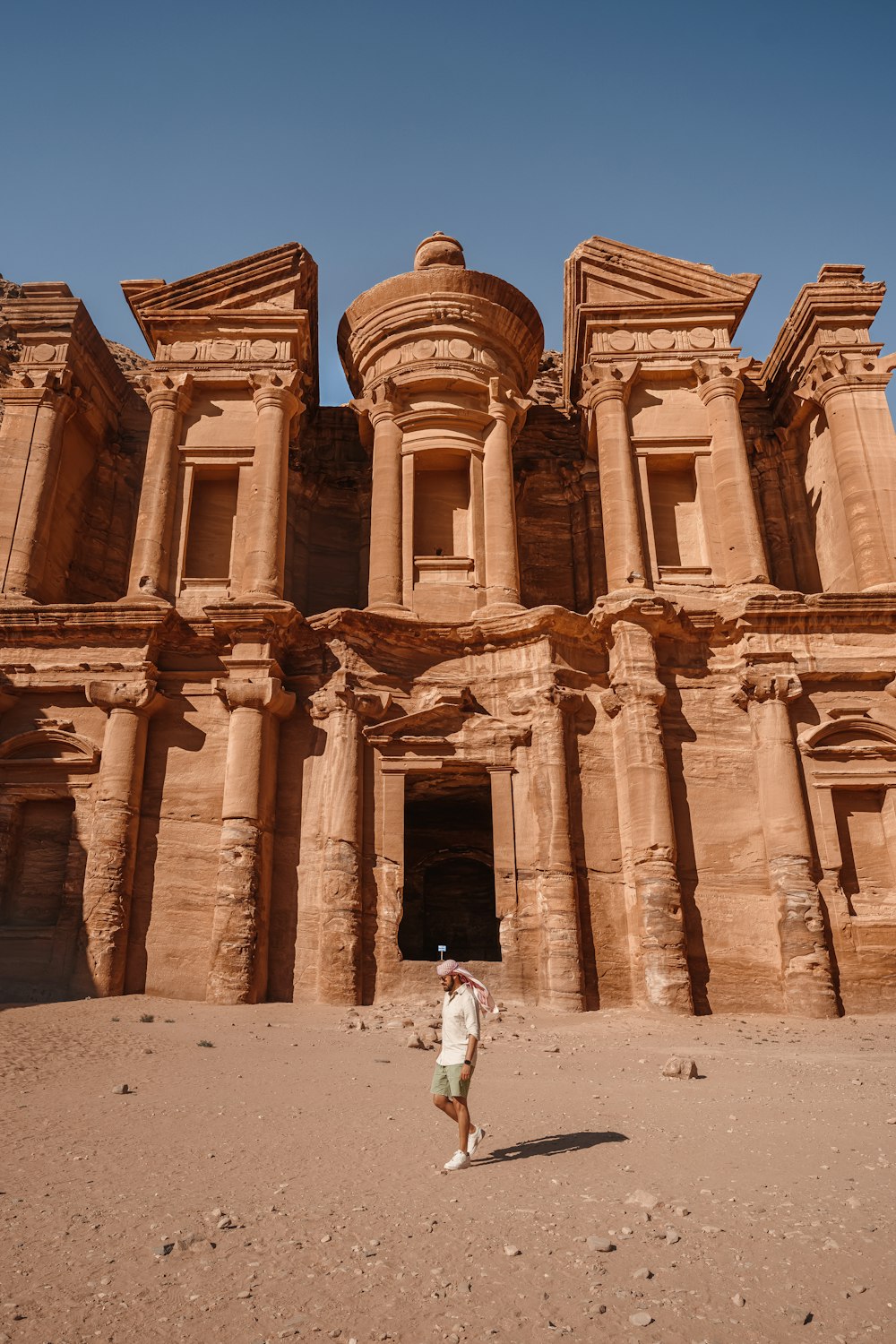 a person standing in front of a large building