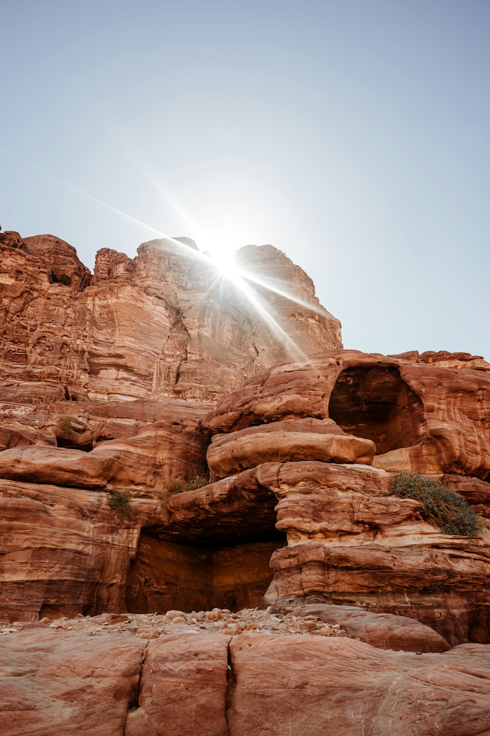 the sun shines brightly over a rocky outcropping