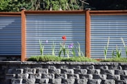 a brick wall with a flower in front of it