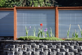 a brick wall with a flower in front of it