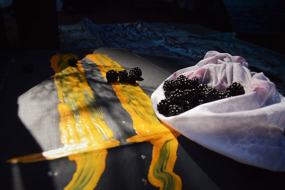 a bag of blackberries sitting on top of a table