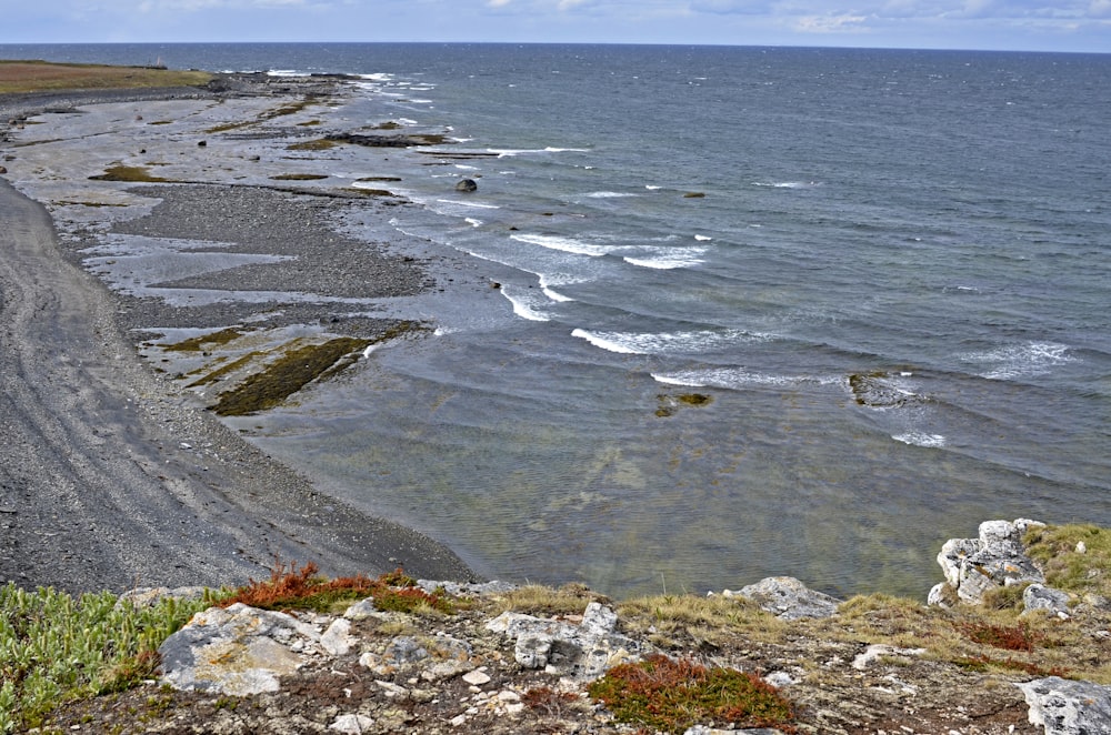 a view of the ocean from a rocky cliff