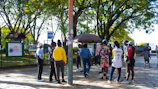 Volunteers distributing sports equipment to kids in a neighborhood park