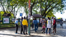 Group of friends competing in kleym, walking and cycling in a park.